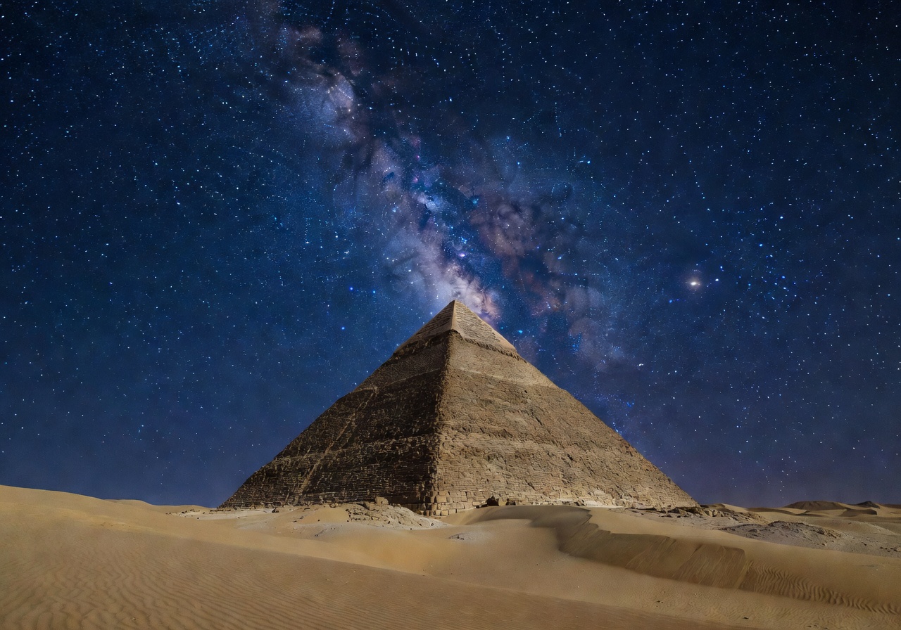 Desert pyramid landscape under starlit sky